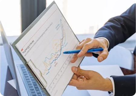 A pen pointing to a clipboard with a graph